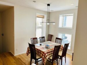 Homeowner gently cleaning a painted interior wall with a soft cloth and mild cleaning solution