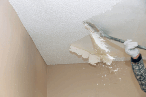 Home interior being prepared for popcorn ceiling removal with protective coverings and proper safety measures