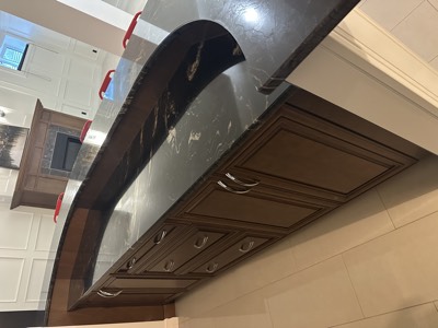 Dark painted bathroom cabinet with granite countertop and vessel sink