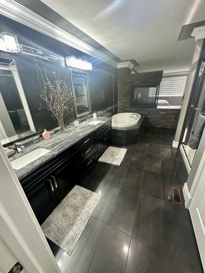 Luxury dark painted bathroom with freestanding soaker tub and spa ambiance