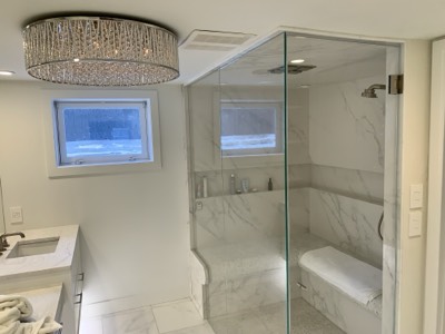 Luxury bathroom with marble walk-in shower and freshly painted walls