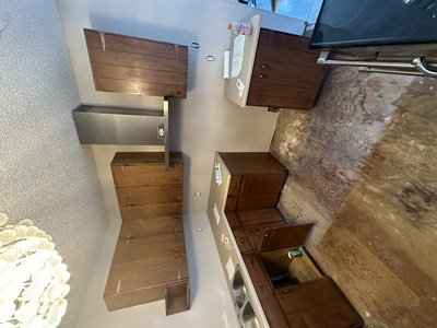 Modern walnut floating vanity in a freshly painted bathroom with clean lines