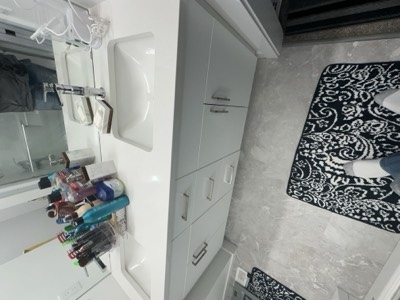 White and grey painted bathroom with linen tower and clean contemporary style