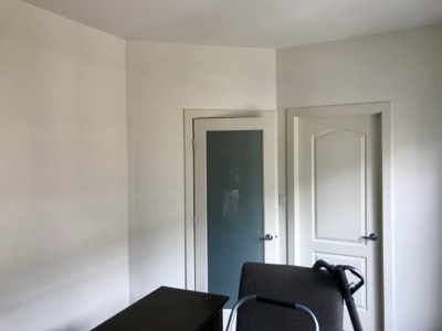 Clean white painted bedroom doors and trim with smooth professional finish