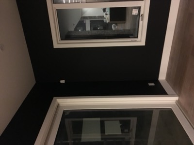 Dark accent wall in a bedroom photographed at night with warm ambient lighting