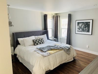 Light grey painted modern bedroom with clean lines and minimalist furnishings
