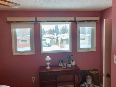 Pink and mauve painted bedroom with large windows and soft natural light