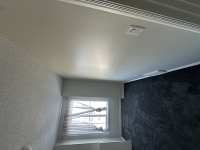 Bedroom with popcorn ceiling removal and smooth freshly painted ceiling