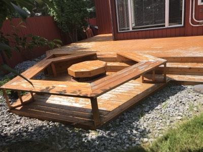 Deck staining project with rich red-toned wood finish and protective coating