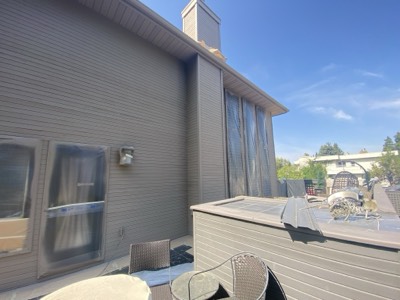 Grey and olive painted exterior with refinished deck and modern landscaping