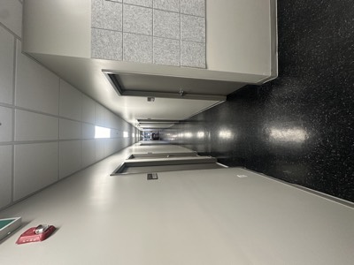 Commercial hallway with sparkle ceiling finish and smooth painted walls