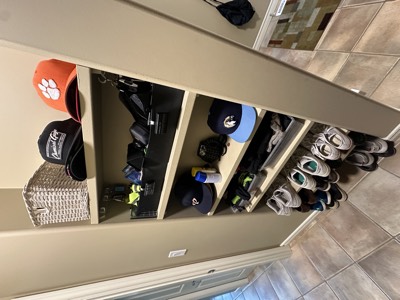 Hallway with painted built-in cubbies and organized mudroom storage area