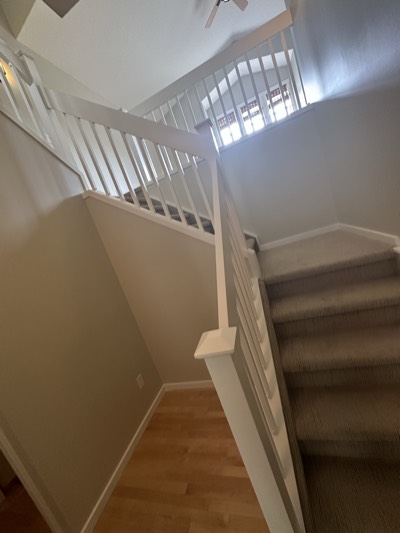 White painted railing with grey walls and modern staircase design