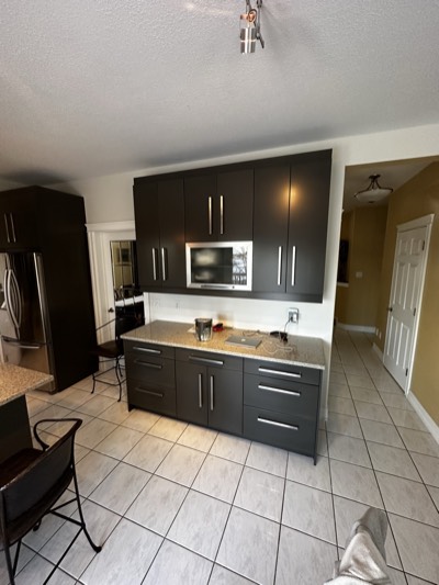 Charcoal flat-panel kitchen cabinets with contemporary minimalist design