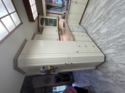 Grand cream painted kitchen with marble countertops and ornate cabinetry