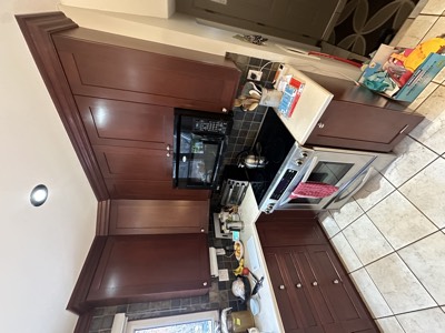 Rich mahogany stained kitchen cabinets with traditional styling and granite surfaces