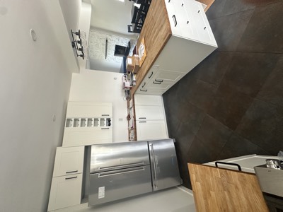 Modern white painted kitchen with built-in wine rack and sleek hardware