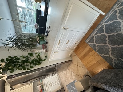 White painted cabinets with gold hardware accents and quartz countertops