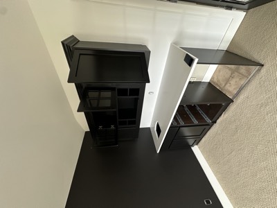 Black painted built-in bar area with LED lighting and modern shelving