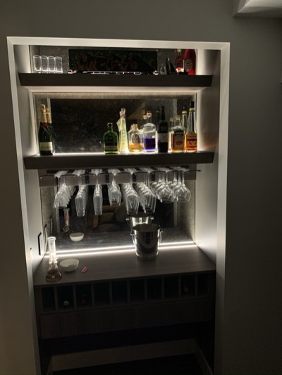 Built-in bar with LED accent lighting and professionally painted cabinetry