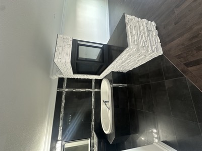 Modern living room with stone fireplace and crisp painted walls and ceiling