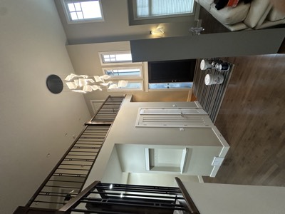 Tall ceiling living room with painted mantel and floor-to-ceiling windows