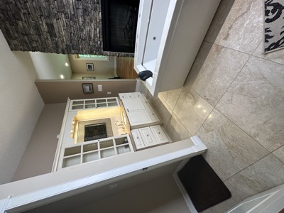 White painted built-in shelving flanking a fireplace in a bright living room