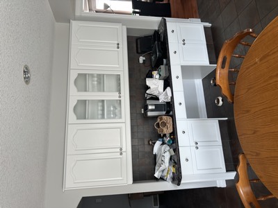 White painted hutch in a combined living and dining room with classic style