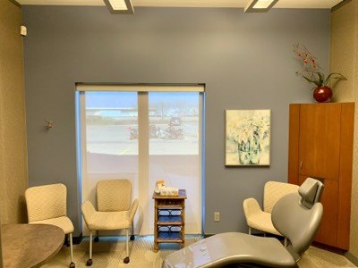 Dental treatment room with grey painted walls and modern medical fixtures