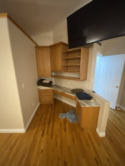 Home office with painted built-in desk, shelving, and organized workspace