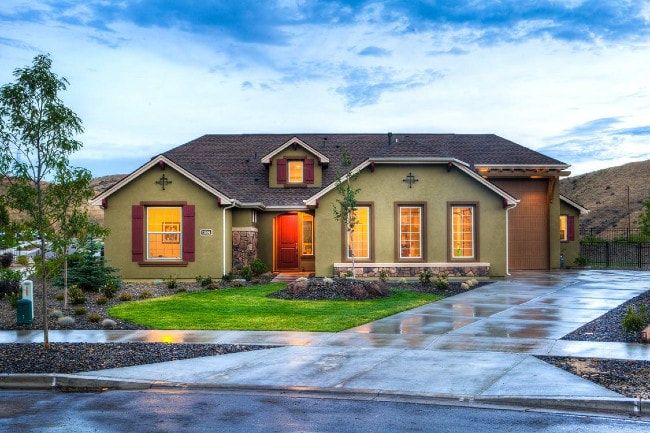 Two-storey home exterior with clean driveway at dusk