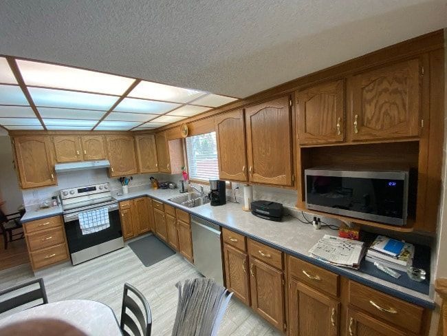 Homeowner preparing and painting kitchen cabinets with proper tools and techniques for a smooth, updated finish