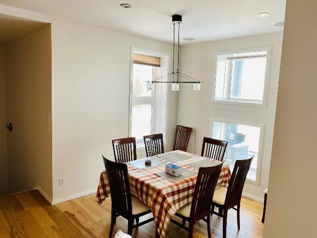 Homeowner gently cleaning a painted interior wall with a soft cloth and mild cleaning solution