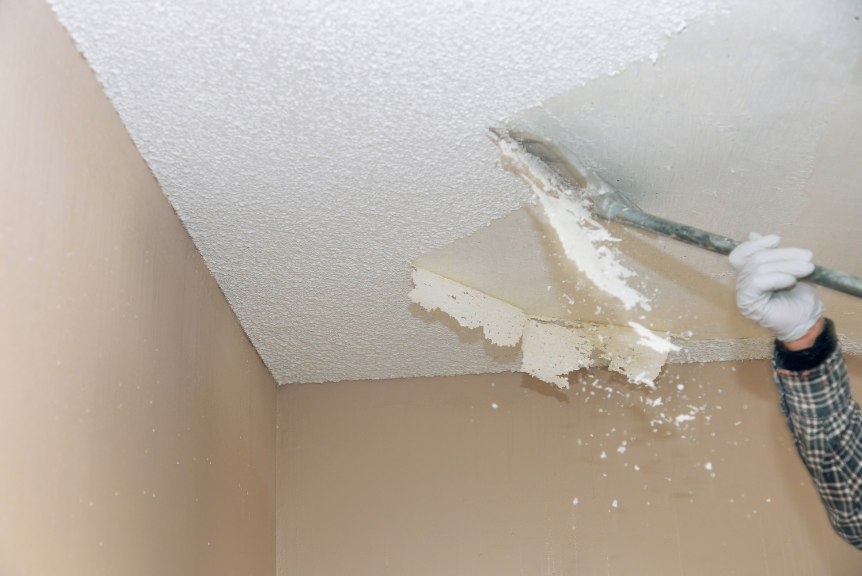 Home interior being prepared for popcorn ceiling removal with protective coverings and proper safety measures