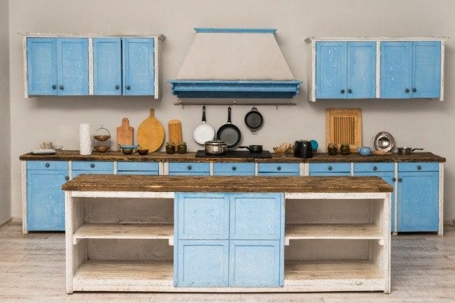 Kitchen cabinets being professionally repainted with proper preparation sanding and coating techniques